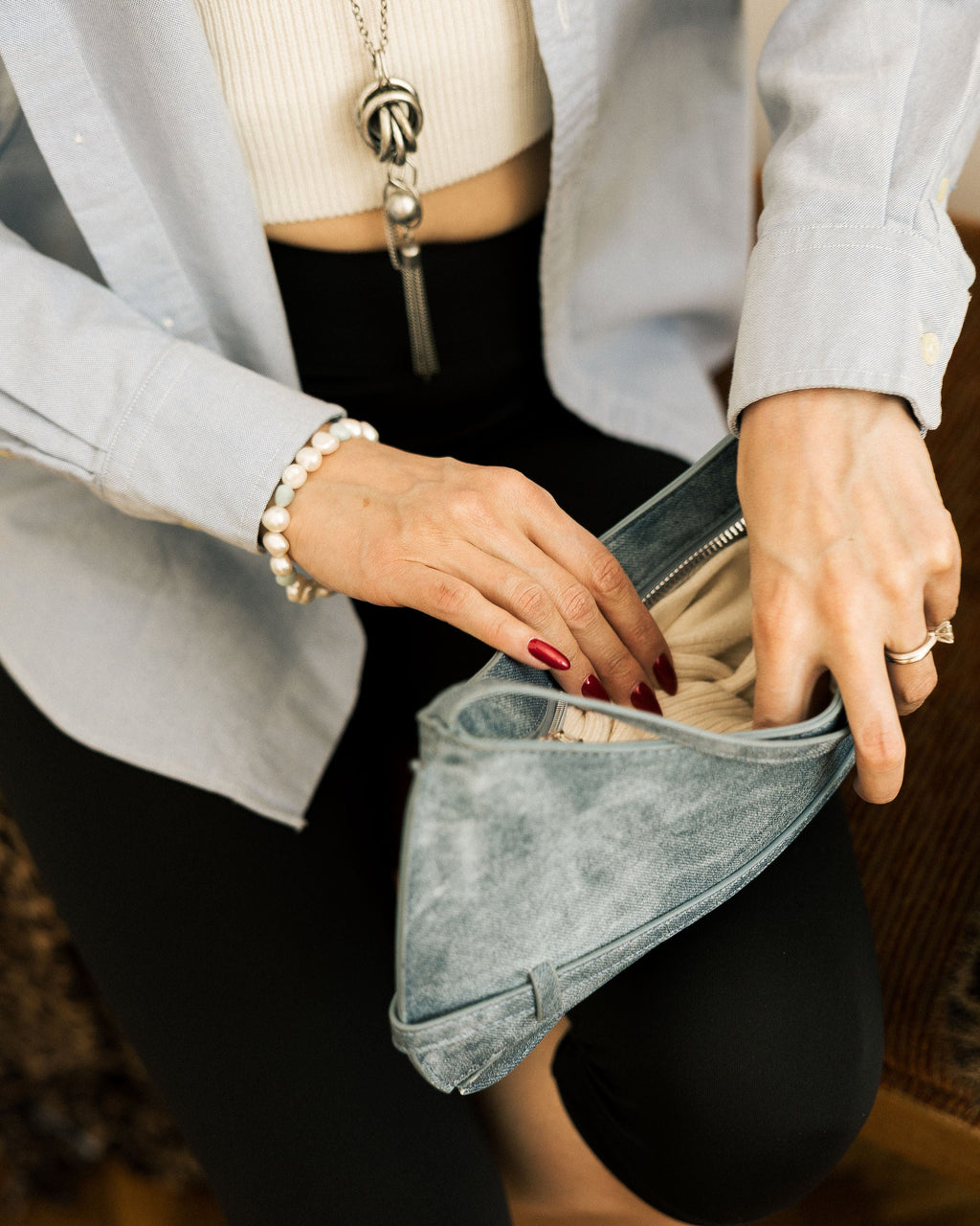 Baroque Freshwater Pearl Bracelet worn on wrist with knot necklace and denim bag in background