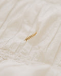 Crystal band ring gold-plated with rhinestones on white fabric