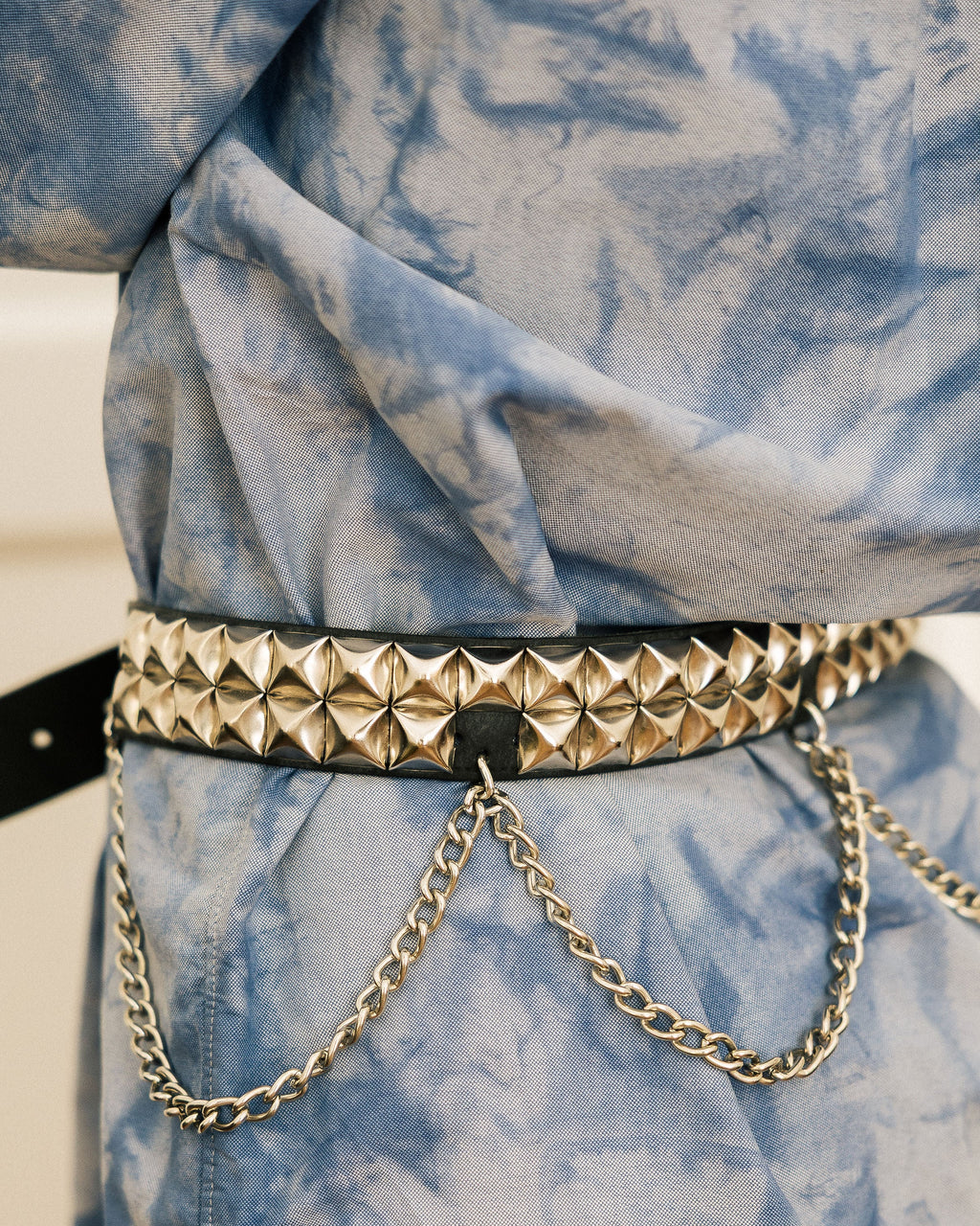 Leather Chain Statement Belt full body shot on model in tie-dye shirt and black leggings