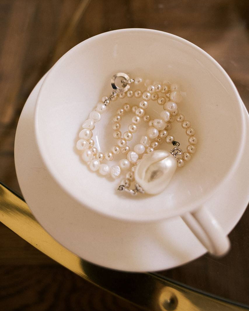 Vintage Faux Pearl Statement Necklace in white cup flat lay